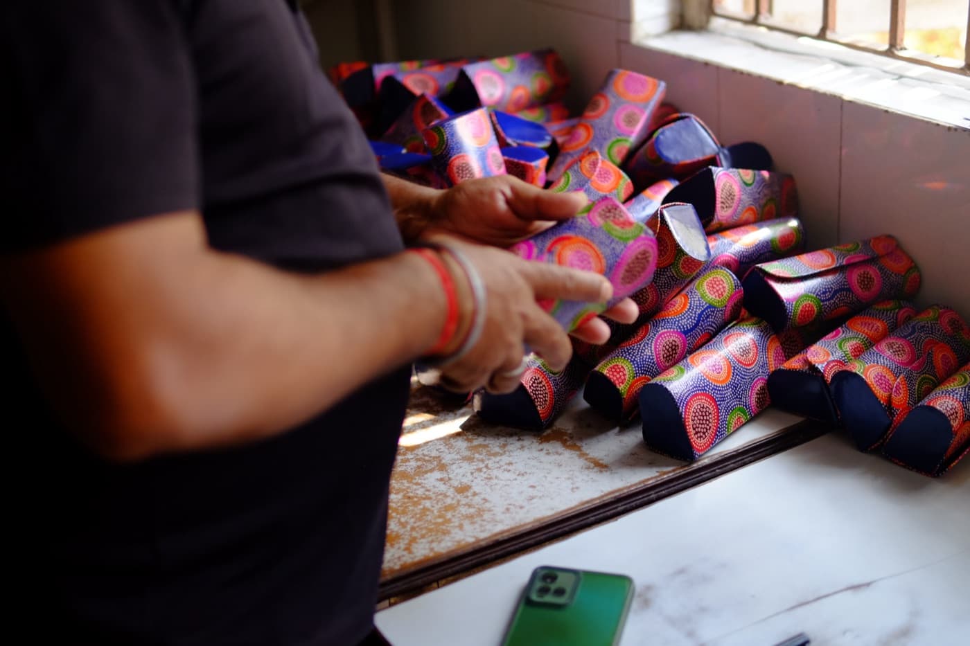 Artisan finishing dyed leather pieces